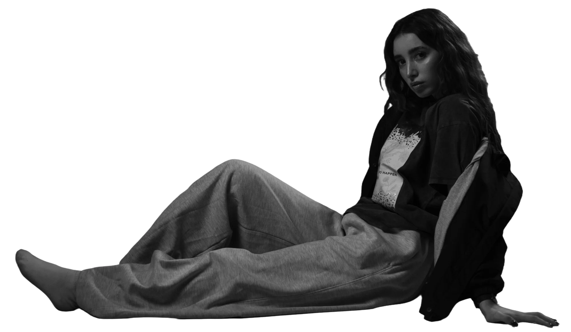 Nancy Bejoun sitting on the floor, looking over her shoulder